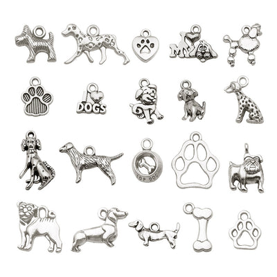 Antique silver dog charms arranged on a light background