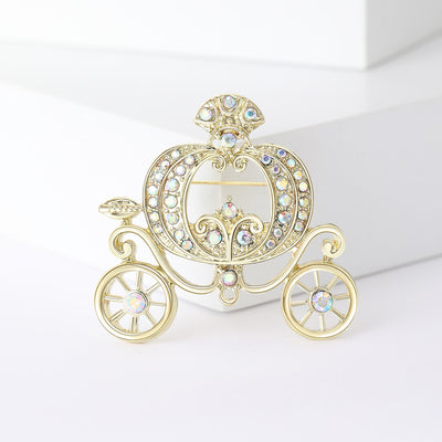 Front view showing the gold tone pumpkin carriage brooch with clear crystals