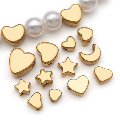 Gold-tone spacer bead beads arranged on a light background
