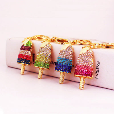 Four rhinestone popsicle keychains in pink, blue, green, and multicolor patterns.