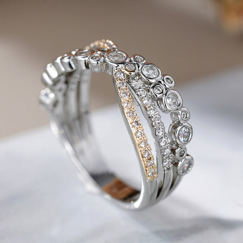 Side angle of two-tone crossed multi-row pavé and bezel ring