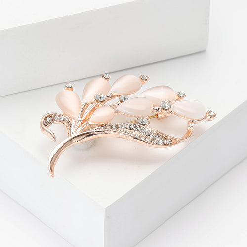 Cat eye stone bouquet brooch angled on white stepped display