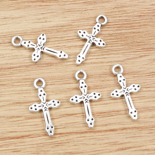 dotted cross charm shown in a close detail view