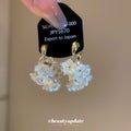 White Flower Cluster Hoop Earrings in Polished Gold Tone view 2