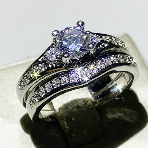 Second product view showing silver-tone round solitaire curved two-ring set