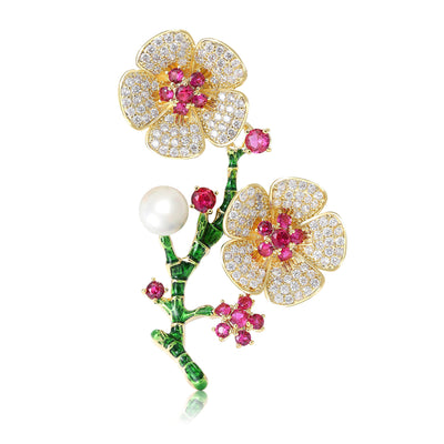 Front view of gold tone flowering branch with pink centers pearls and green enamel stems