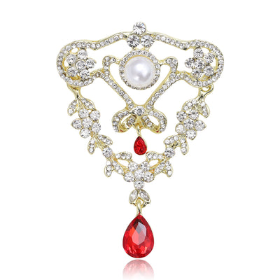 Front view of ornate pearl and crystal drop brooch with teardrop dangle