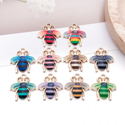 Colorful bee charms arranged on a light background