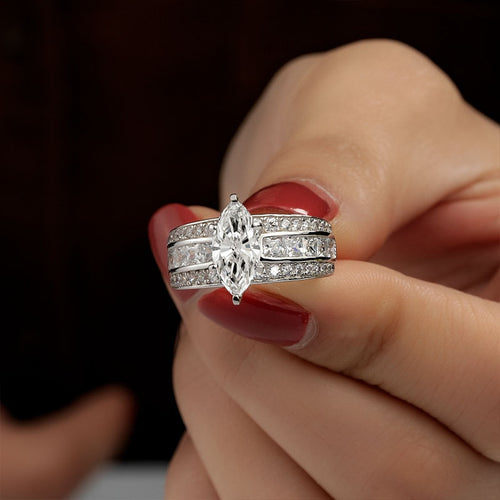 Product view showing silver-tone marquise solitaire triple-row wide ring