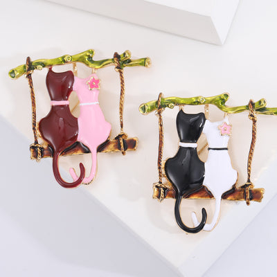 Front view of two cats on a swing enamel brooch decorative metal pin