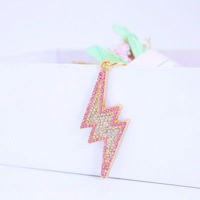 Pink and clear rhinestones cover a gold-tone lightning bolt charm.