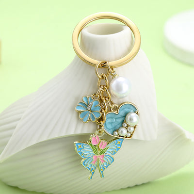Image 1 showing a white vase with a keychain and a butterfly.