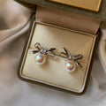 Bow and Pearl Stud Earrings in Gold and Dark Silver view 7