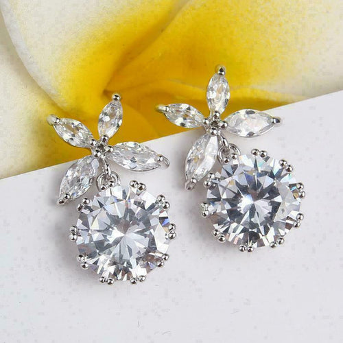 Styled view showing a round clear drop beneath a marquise leaf cluster
