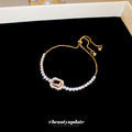 Gold Tone Crystal Slider Bracelet With Pale Pink Rectangular Center Stone view 2