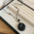 Black and Brown Cord Necklaces with Round Wood Look Pendants view 6