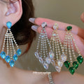 Gold Crystal Teardrop Chandelier Stud Earrings with Polished Metal Details view 2