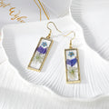 Gold Tone Slim Rectangular Pressed Flower Drop Earrings in Four Designs view 5