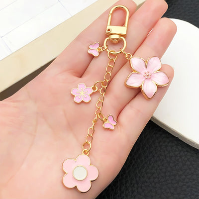Overview showing the available color and design variations of the pink and blue blossom butterfly metal clasp keychain