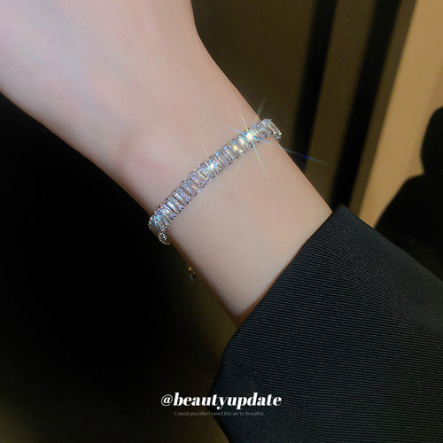 silver-tone tennis bracelets with three visibly different clear stone rows shown worn in a styled second view