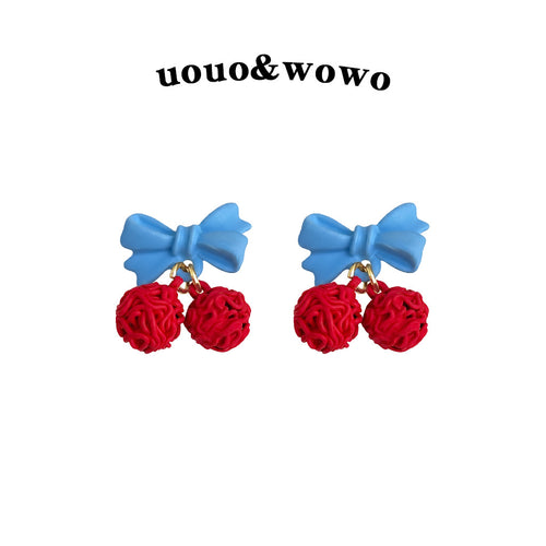 Light blue bow red cherry drop studs on white product background