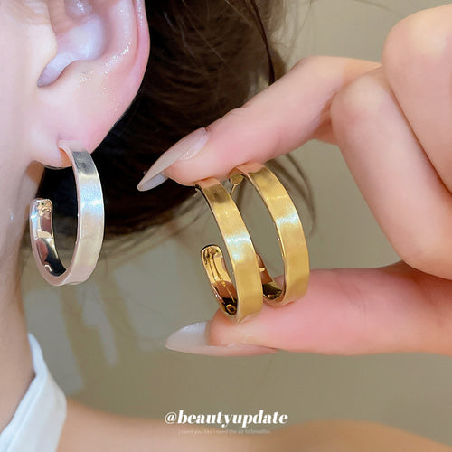 Small rounded hoops with a clean polished curved profile displayed from the front.