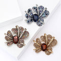 Iris Flower Brooch in Metal with Crystal Petals and a Faceted Center view 1
