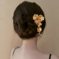 Gold Tone Floral Hair Pin With Textured Petals And Long Leaf Drop view 3