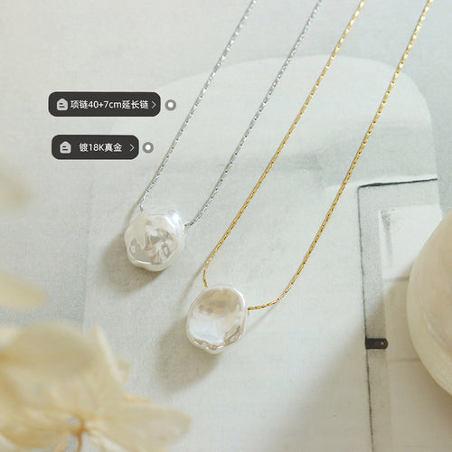 Gold and steel baroque pearl pendants on book with length labels
