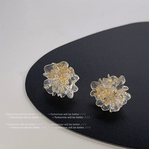 Clear resin gold fleck flower studs on black mat