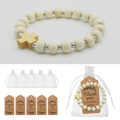Ivory wooden bead cross bracelet shown beside white drawstring bags and brown thank-you tags.