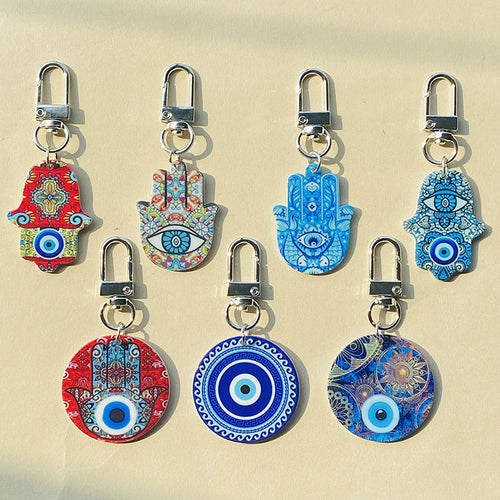 Seven of the printed hand and circle keychains arranged in two rows