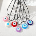 Round Resin Evil Eye Pendant Necklaces on Black Cords view 1