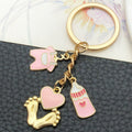 Eight Pink Baby Bottle Outfit and Footprint Keychain Designs view 3