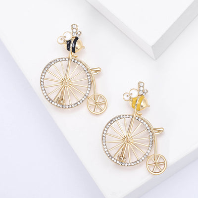 Front view of the penny farthing rider brooch showing a tiny rider on a crystal-spoked penny-farthing bicycle