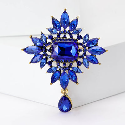 Front view of the radiant crystal dangle brooch showing a radiant crystal cluster with a rectangular center and teardrop