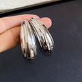 Layered Ridged Crescent Stud Earrings in Two Metal Tones view 7