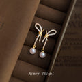 Gold Tone Clear Stone Bow Long Tail And White Pearl Stud Earrings view 6
