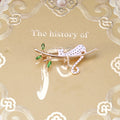 White Enamel Spotted Cat Brooch Gold Branch Green Leaves view 6