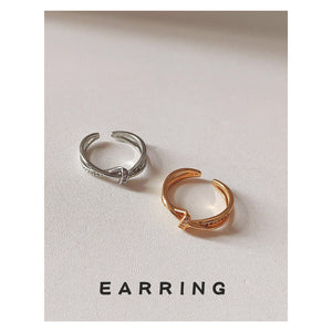 Crossed Open Rings In Polished Silver And Gold Tone