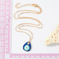 Gold Tone Layered Navy and Aqua Evil Eye Teardrop Earrings view 3