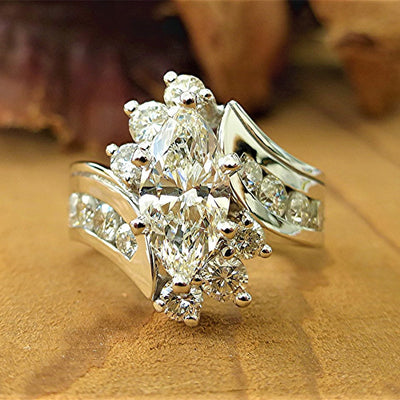 Product view showing silver-tone marquise clear cluster three-stone ring