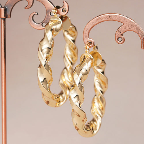 Gold Tone Twisted Rope Hoop Earrings Polished Statement Fashion Jewelry shown in a styled view