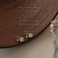 Gold Tone Curved Branch White Flower And Clear Stone Stud Earrings view 4