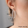 Single-Row Clear Stone Large Oval Hoop Earrings In Silver Tone view 4