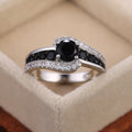 Black And Blue Round Stone Swirl Ring In Four Metal Finishes view 2