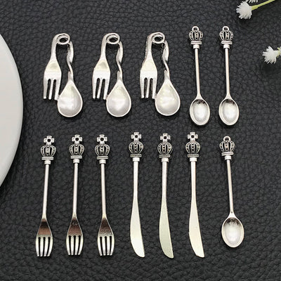Black crown charms arranged on a light background