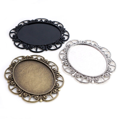 Ornate Oval Cabochon Pendant Bezel Settings in Three Finishes, grouped overview on a plain background