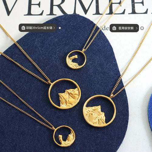 Gold mountain and wave pendants flat lay with length labels