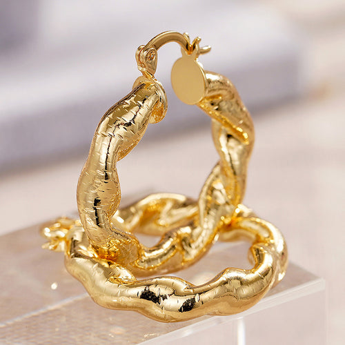 Alternate close view of the gold tone earrings